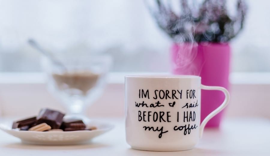 A cup saying "I'm sorry for what I said before I had my coffee "